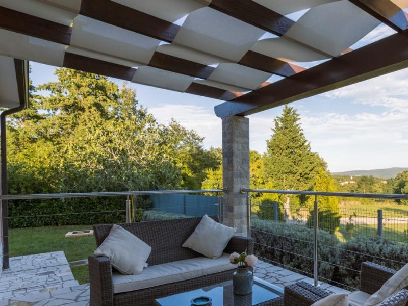 Wicker patio furniture under a pergola